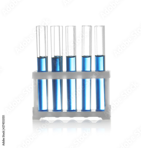 Test tubes with liquid samples in rack on white background. Chemistry glassware