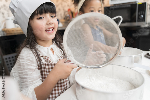 Group of kids are preparing the bakery in the kitchen .Children learning to cooking cookies
