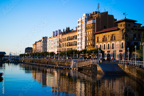 View of the dock of Gijon, Asturias, Spain, with reflections in the water, in Cimadevilla, the old town, during the sunset. Peaceful place