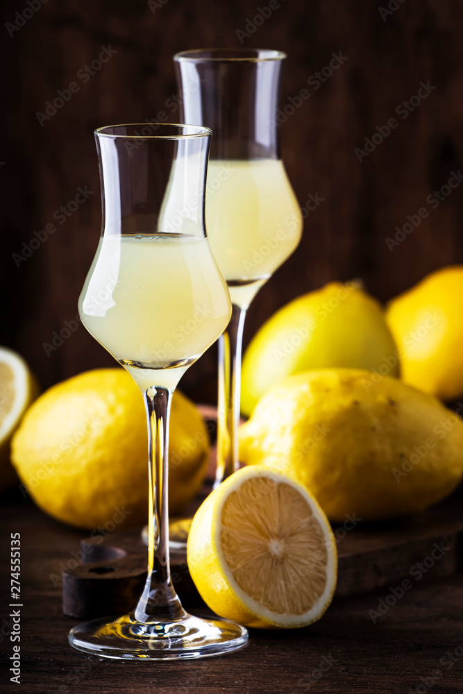 Limoncello, sweet Italian lemon liqueur, traditional strong alcoholic drink. Still life in vintage style, selective focus Limoncello, sweet Italian lemon liqueur, traditional strong alcoholic drink. Still life in vintage style, selective focus