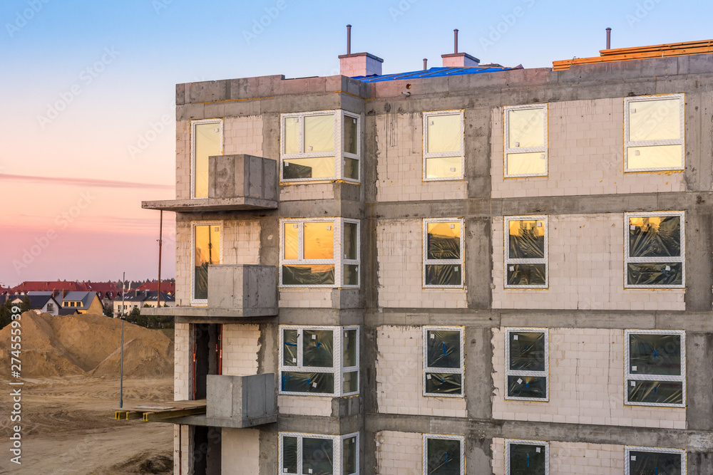 Modern apartment building on a construction site.