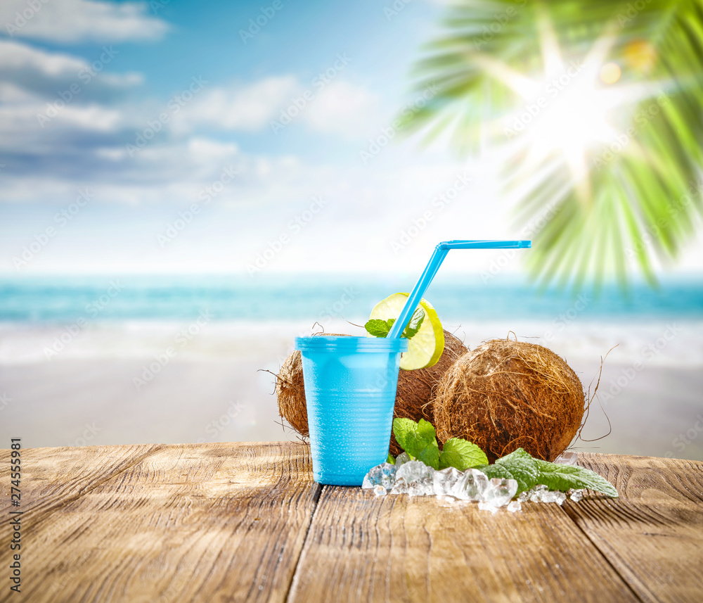 Summer drink and beach landscape  - obrazy, fototapety, plakaty 
