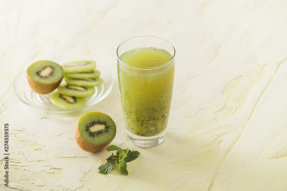 Cocktail with kiwi and mint in a glass on a white background. Selective focus. Cocktail with kiwi and mint in a glass on a white background. Selective focus.