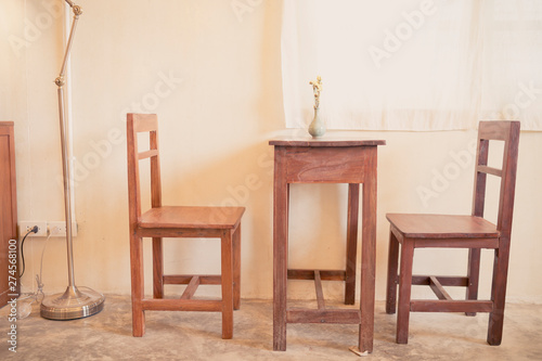 vase on wooden table and chairs furniture in cafe