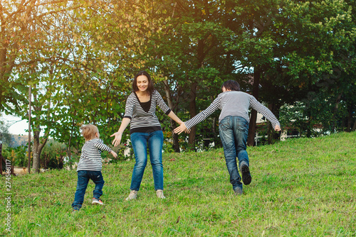 Happy family having fun outdoors.Young family enjoying life, together on nature. Happy family lifestyle. Family look. Concept of friendly family. Family vacations in countryside.