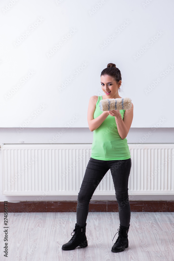Young beautiful woman doing renovation at home Young beautiful woman doing renovation at home