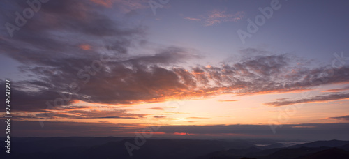 Panoramic view of colorful clouds at the sunrise in mountains