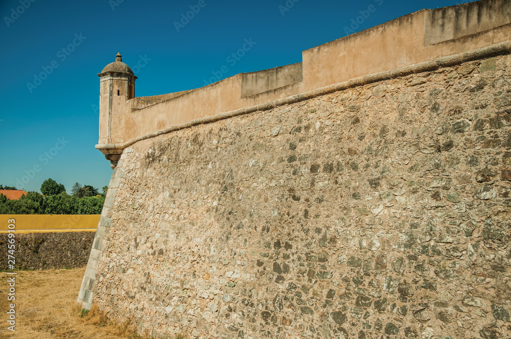 Stone city wall corner with watchtower and dry moat Stone city wall corner with watchtower and dry moat