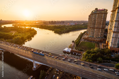 Panorama of Moscow at sunset, Russia. Aerial scenic view of Moskva River in Moscow northwest. Beautiful landscape of Moscow in sunny evening. Scenery of Moscow with Stroginsky bridge in sun light. photo
