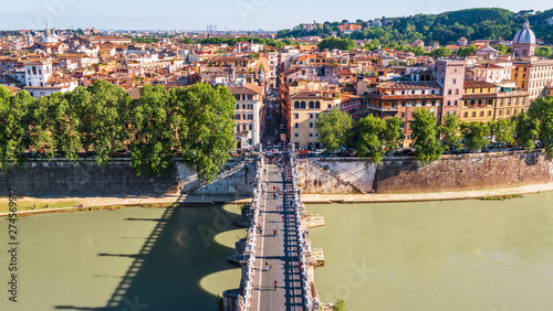 Bridge of Sant'Angelo in Rome, Italy. It is one of the top landmarks of Rome. Panoramic view of the Rome city from above. Embankment of Tiber River in summer. Cityscape of old Rome on sunny day.