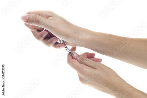 Woman hands using a nail clippers to cut her fingernails.