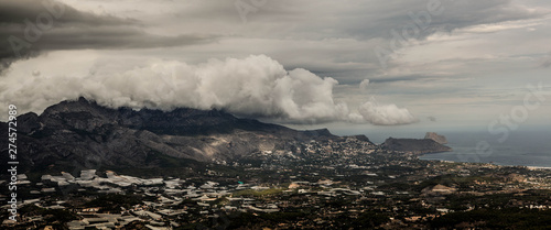 Mountain range covered with thunderstorm clouds, wide panoramic view, Spain, Benidorm.