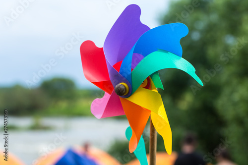 A child's pinwheel against a blue sky. Shot outside with studio lighting