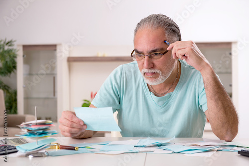 White bearded old man in budget planning concept  photo