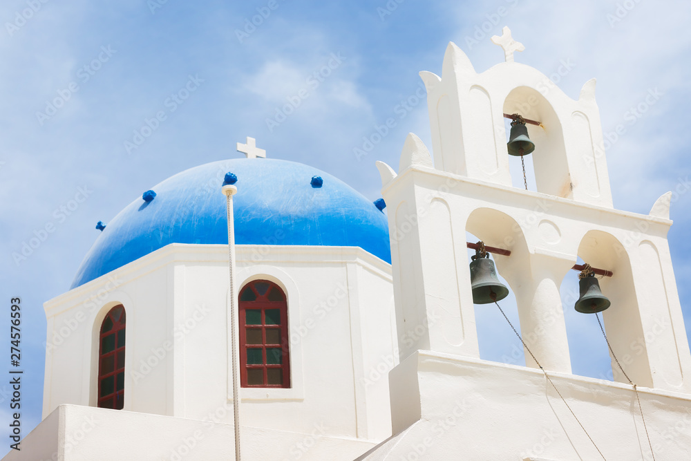 Famous beautiful Orthodox church with blue dome in Oia on Santorini island, Greece