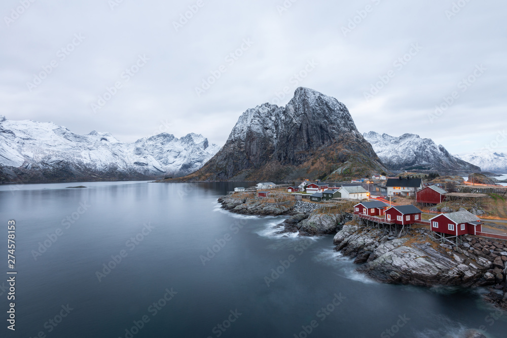 Red fishing house village among the snow with mountain view in Lofoten island Hamnoy Norway