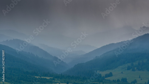 Heavy rain  storm over the valley at summertime in the Carpathian mountains.