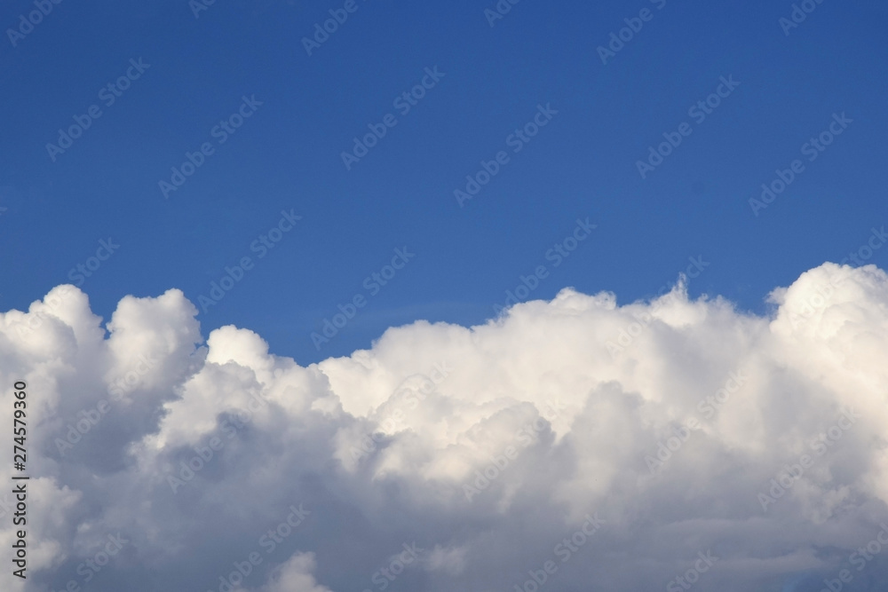 Blue sky with clouds background. Sky with cumulus clouds. Big air clouds in the blue sky. Selective focus. Copy space. Blue sky with clouds background. Sky with cumulus clouds. Big air clouds in the blue sky. Selective focus. Copy space.