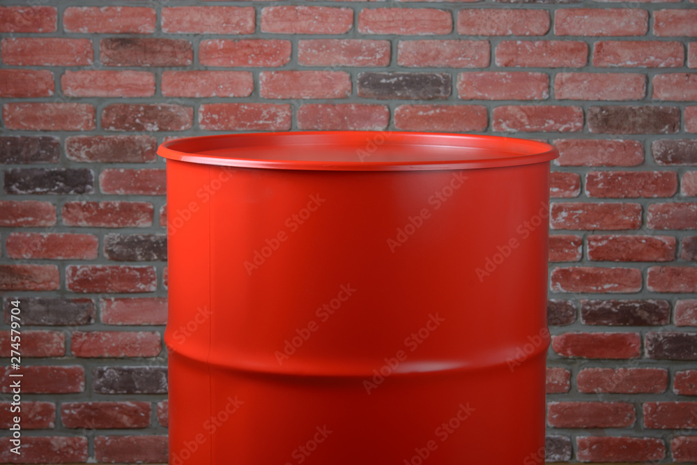 Large Iron Red Barrel on a brick wall background Large Iron Red Barrel on a brick wall background