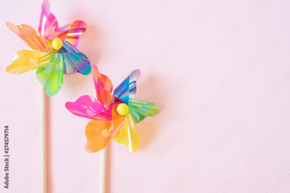Colorful pinwheel. Plastic windmill children's toy. Background with copy space. Matte filter added Colorful pinwheel. Plastic windmill children's toy. Background with copy space. Matte filter added