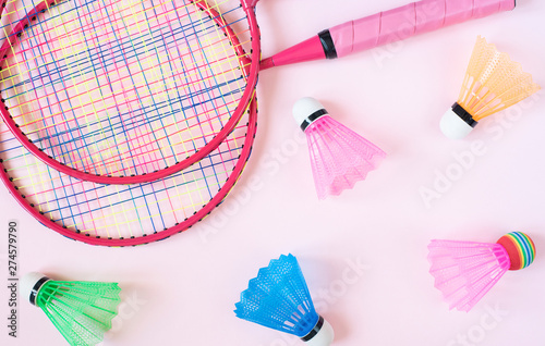 Badminton equipment. Badminton rackets and shuttlecocks on pink background. Top view  copy space