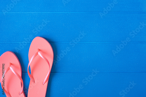 Flip flops on blue wooden background. Summer concept. Flat lay, top view, copy space