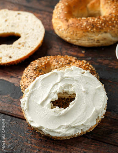 Bagels sandwich with cream cheese on wooden table
