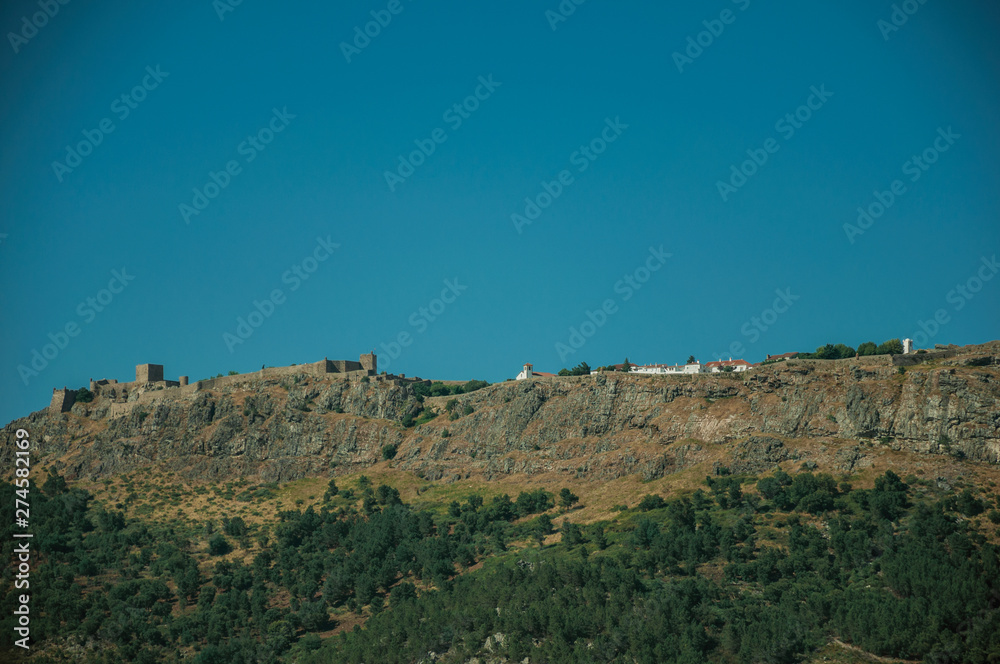 Marvao village on top of tall crag with stone walls and towers