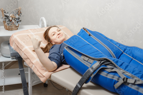 woman on pressure therapy. girl smiles and shows thumbs up, everything is fine. health care concept.