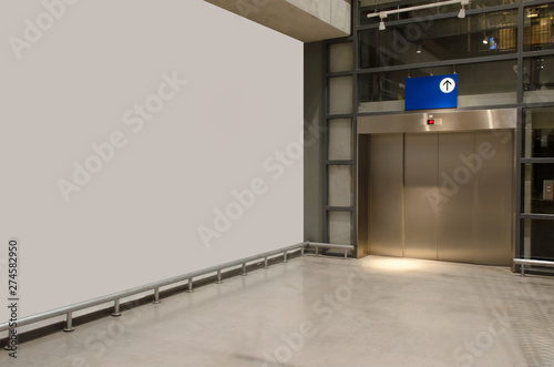 interior corridor in hall with white wall and elevator in modern office elegant building, subway train station, airport or department store shopping mall, interior and architecture concept