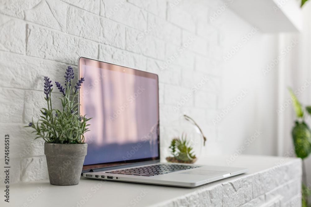 using laptop with blank screen on desk in home interior using laptop with blank screen on desk in home interior