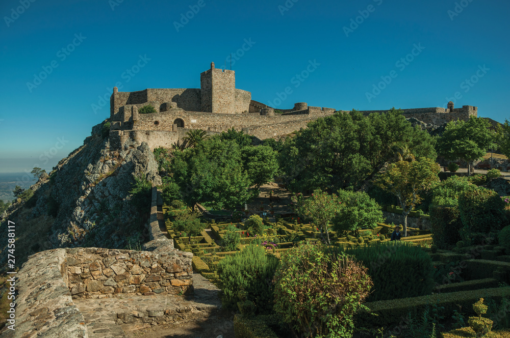 Stone walls and tower of Castle over rocky cliff at Marvao