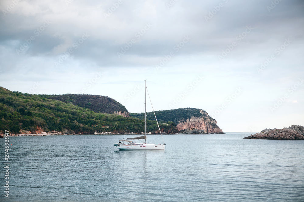 Sailboat or sailing boat in the sea near the coast. Sailboat or sailing boat in the sea near the coast.