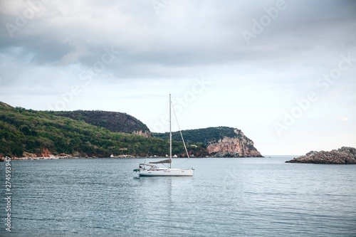 Sailboat or sailing boat in the sea near the coast.