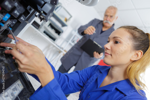 female technician fixing a printer