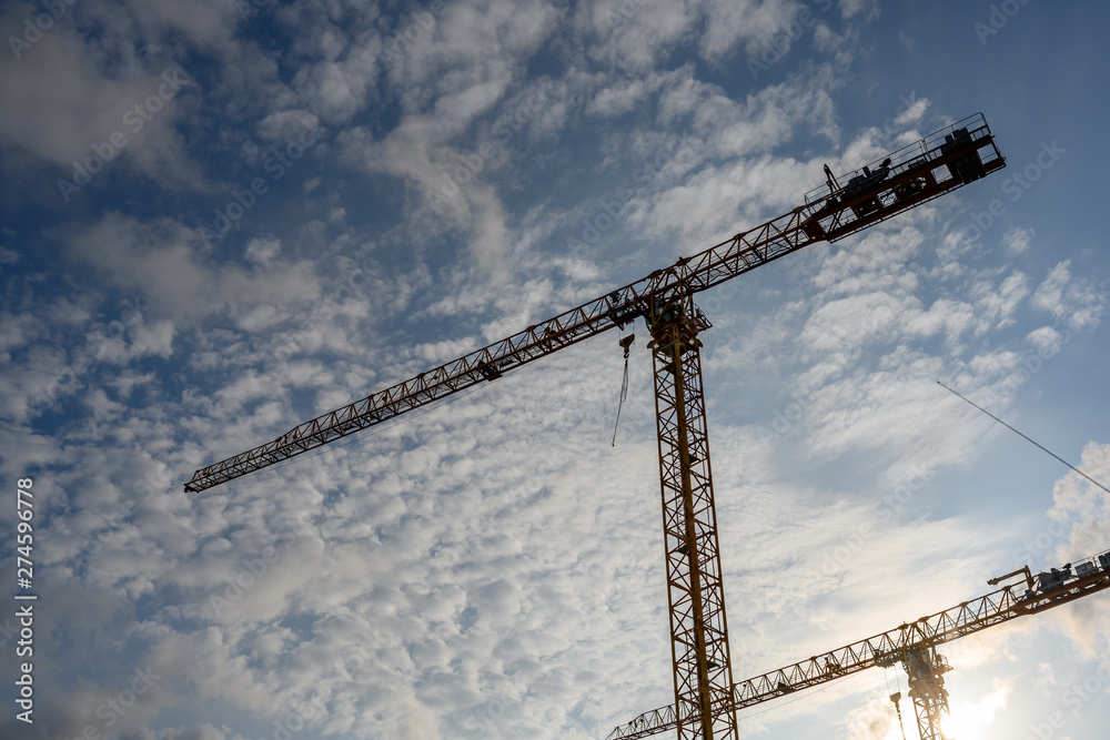 Tower Crane in the clouds and blue sky..