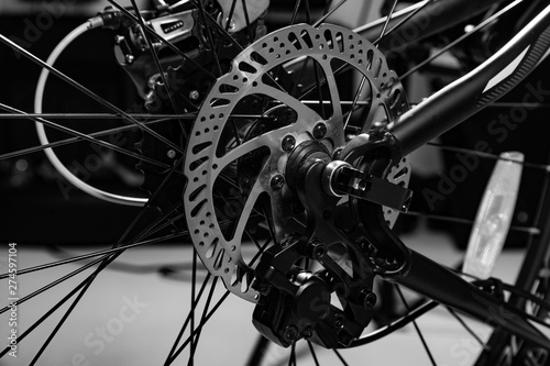close-up shot of named mechanic brake disc on bicycle in black and white