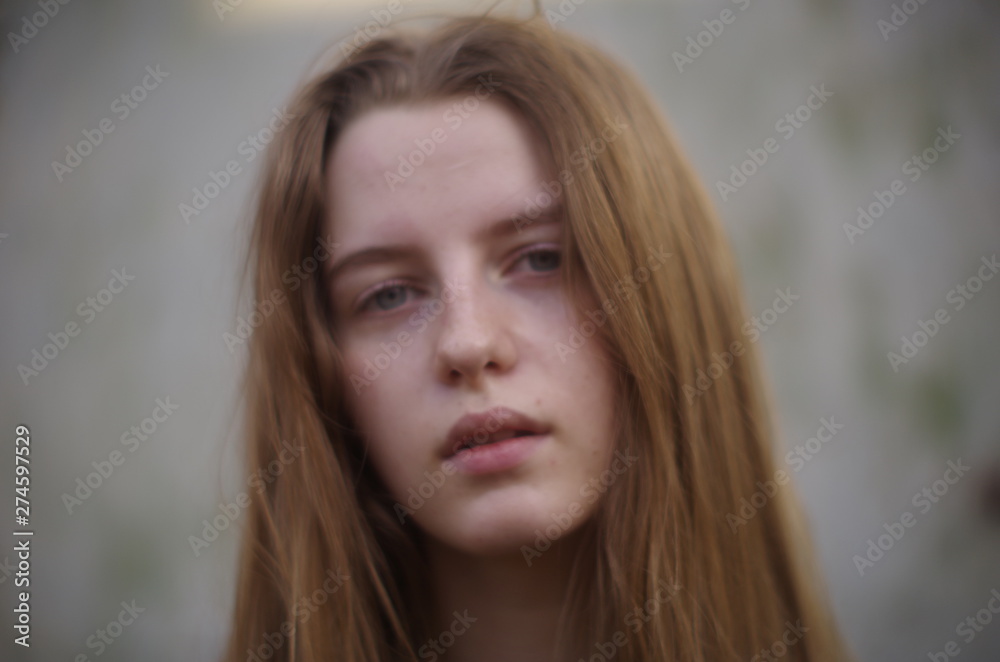 beautiful young blonde with long flowing hair on a blurry background beautiful young blonde with long flowing hair on a blurry background