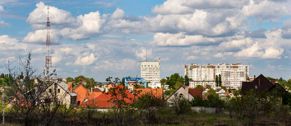 Outskirts of Chisinau. Panorama with the capital of Moldova. Cloudy sky before the rain. - obrazy, fototapety, plakaty 