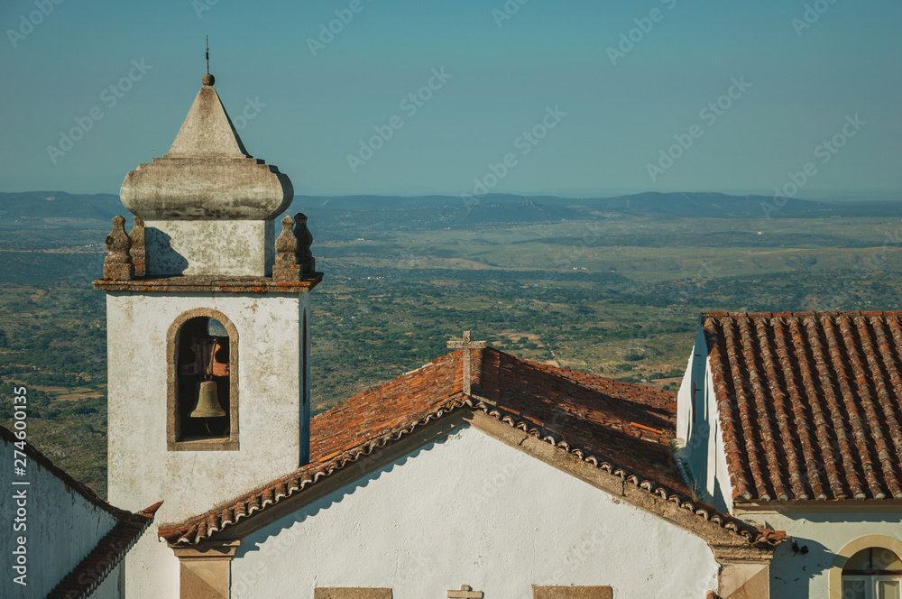 Old church steeple with bell in baroque style at Marvao