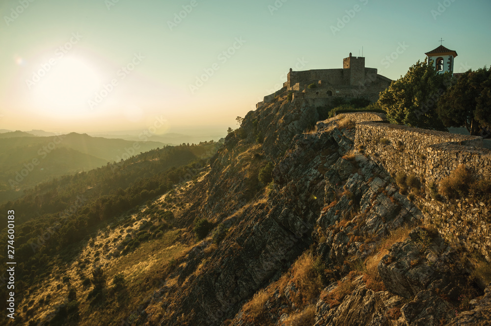 Stone wall and tower of Castle over ridge in Marvao