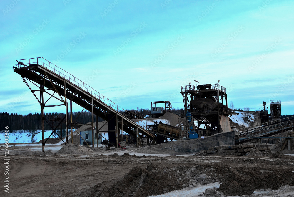 Sand mining in winter conditions in an industrial quarry. Conveyor Belt in mining quarry, Mining industry. Amazing mountains against the backdrop of snow and industry Sand mining in winter conditions in an industrial quarry. Conveyor Belt in mining quarry, Mining industry. Amazing mountains against the backdrop of snow and industry