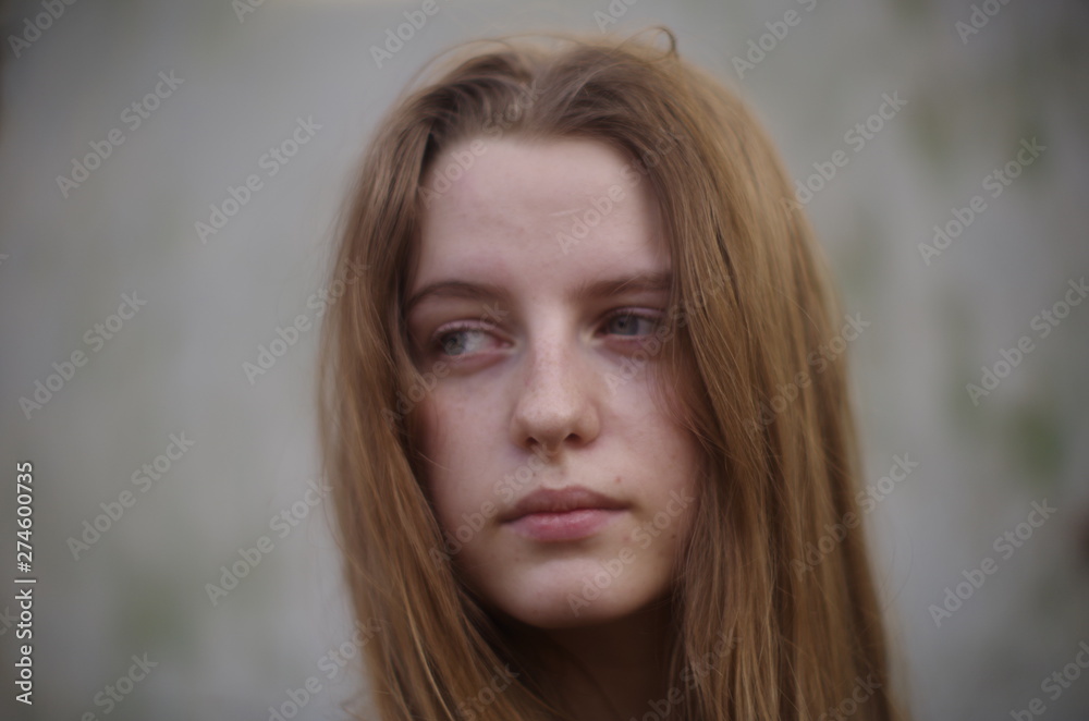 beautiful young blonde with long flowing hair on a blurry background beautiful young blonde with long flowing hair on a blurry background
