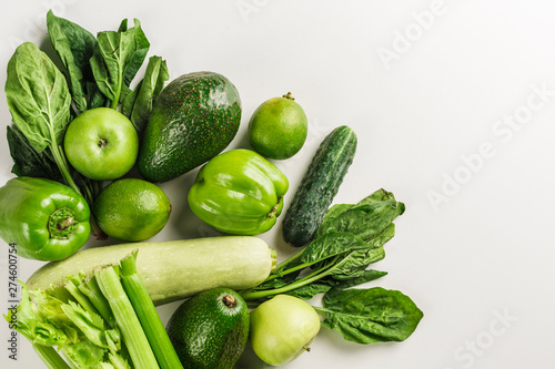 Green vegetables and fruits on white background