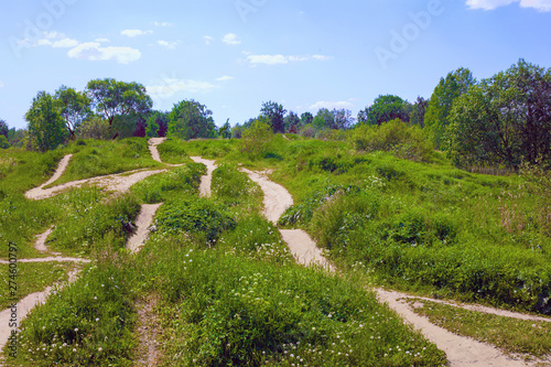 Many paths of different directions on the green hills