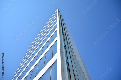 New office building in business center. Wall made of steel and glass with blue sky.  © Grand Warszawski