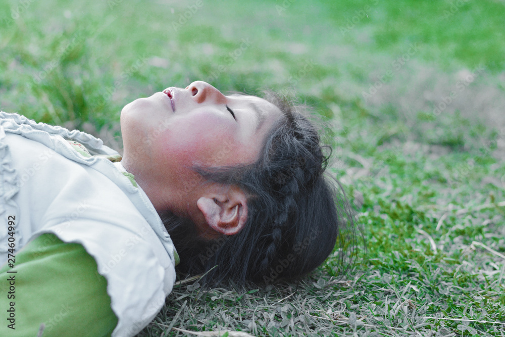 Calm native american kid laying on the grass. Calm native american kid laying on the grass.