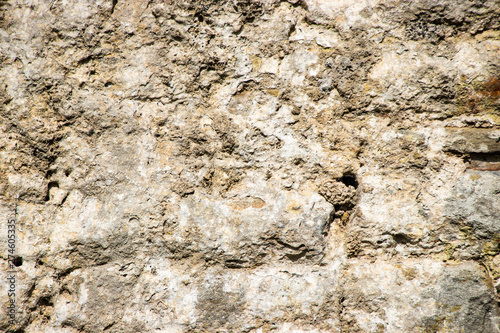 Old rough weathered stone wall texture