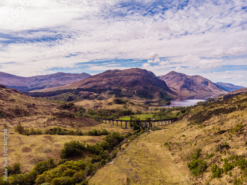 Glenfinnan viaduct and historical train in Scotland © marekzatko