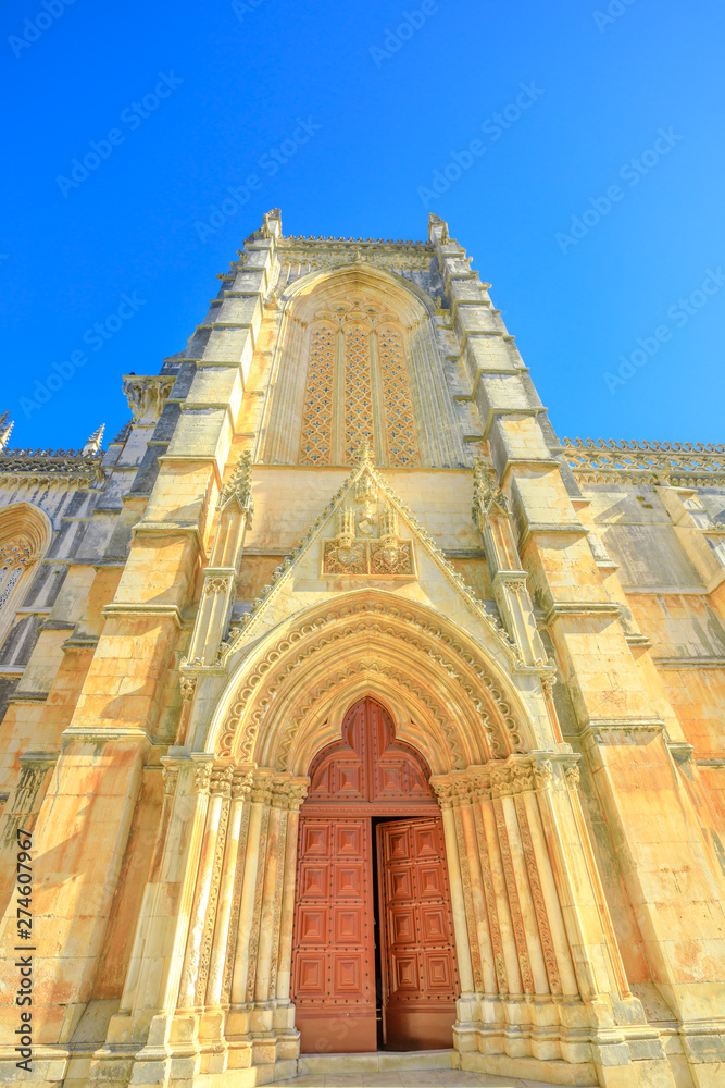 Main portal with tympanum and archivolts of Batalha Monastery, one of best examples of Gothic architecture in Portugal and Dominican convent of Saint Mary of the Victory in Batalha. Vertical shot.